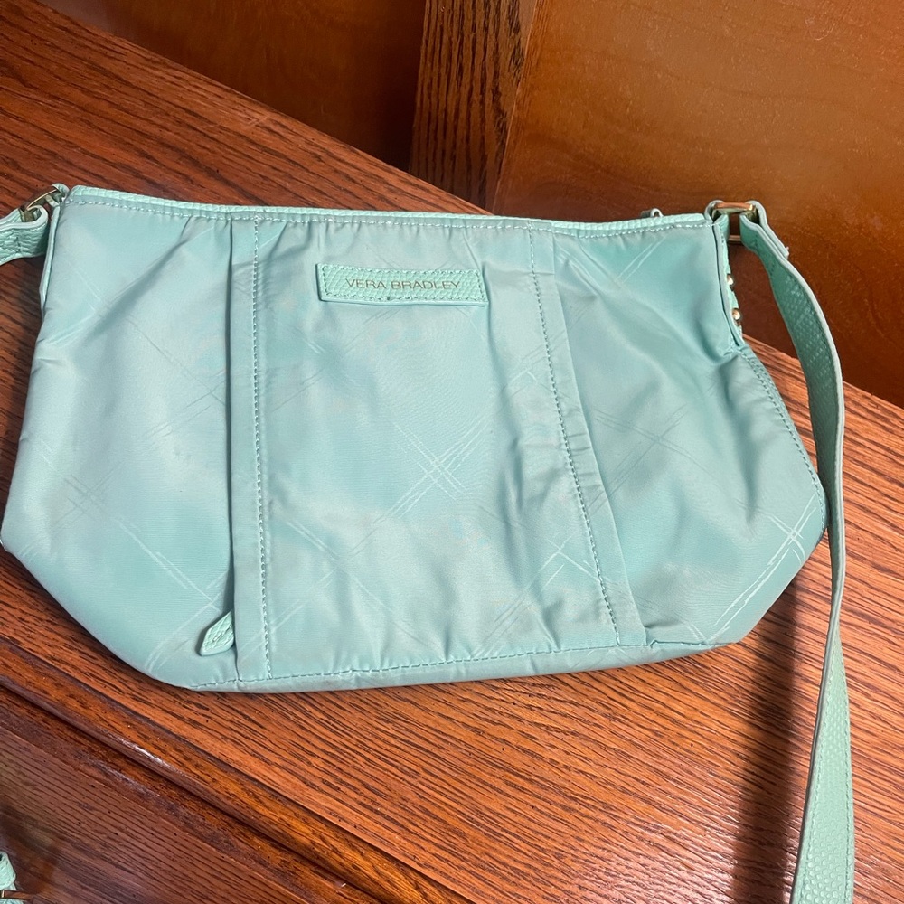 Turquoise vinyl Vera Bradley crossbody bag, with adjustable strap